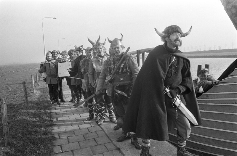 The Norsemen pose with their weapons