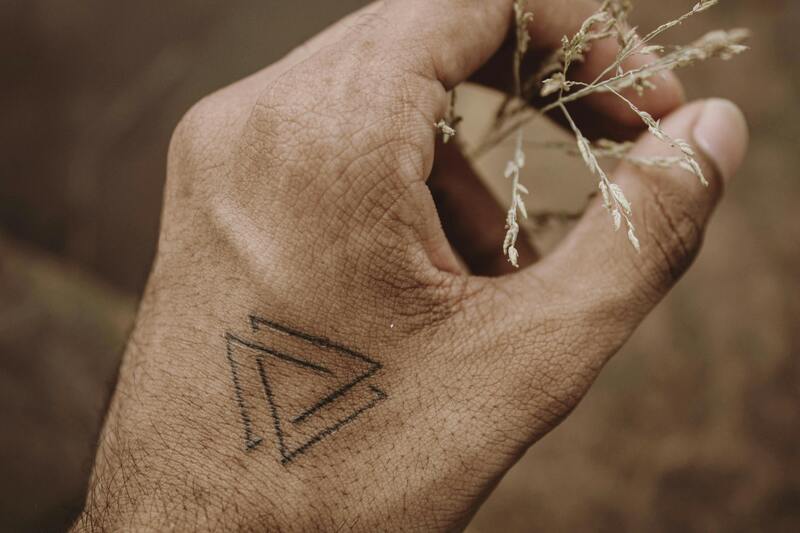 Tattoo depicting a valknut symbol