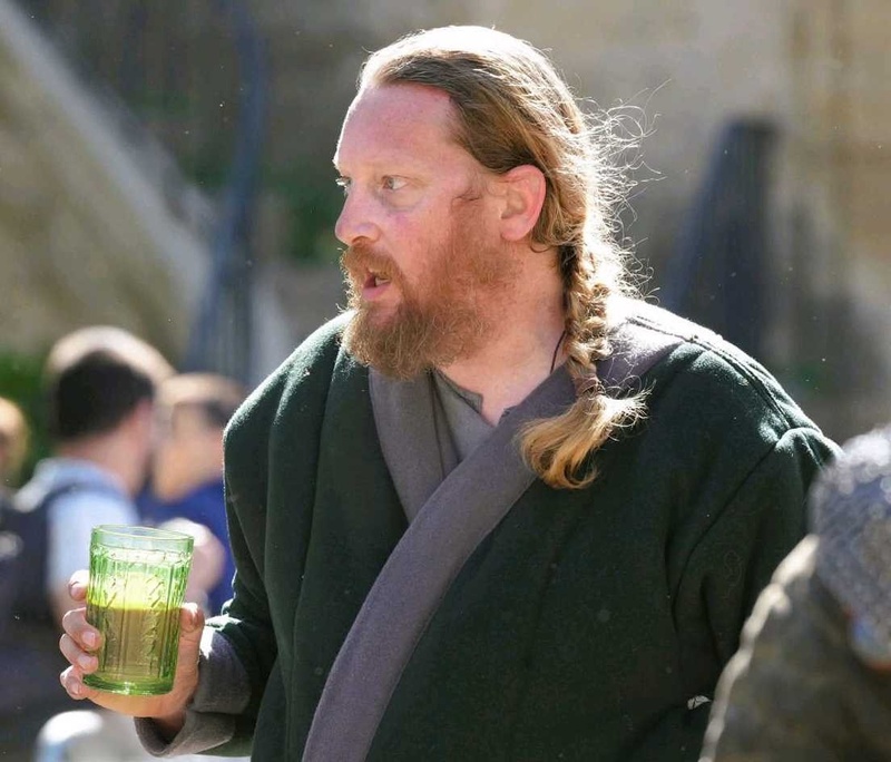 Reenactor (contributor) with replica glassware