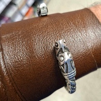 A replica Viking Age arm ring with beast heads